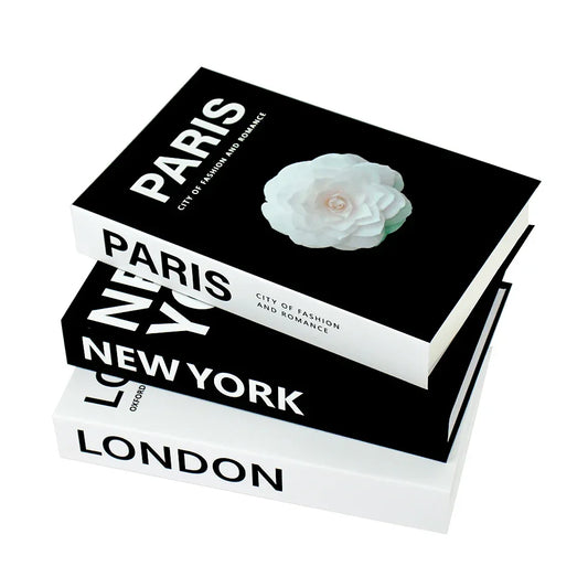 Set of four decorative books titled ‘London’, ‘New York’, and ‘Paris’ with flower illustration, elegant white background
