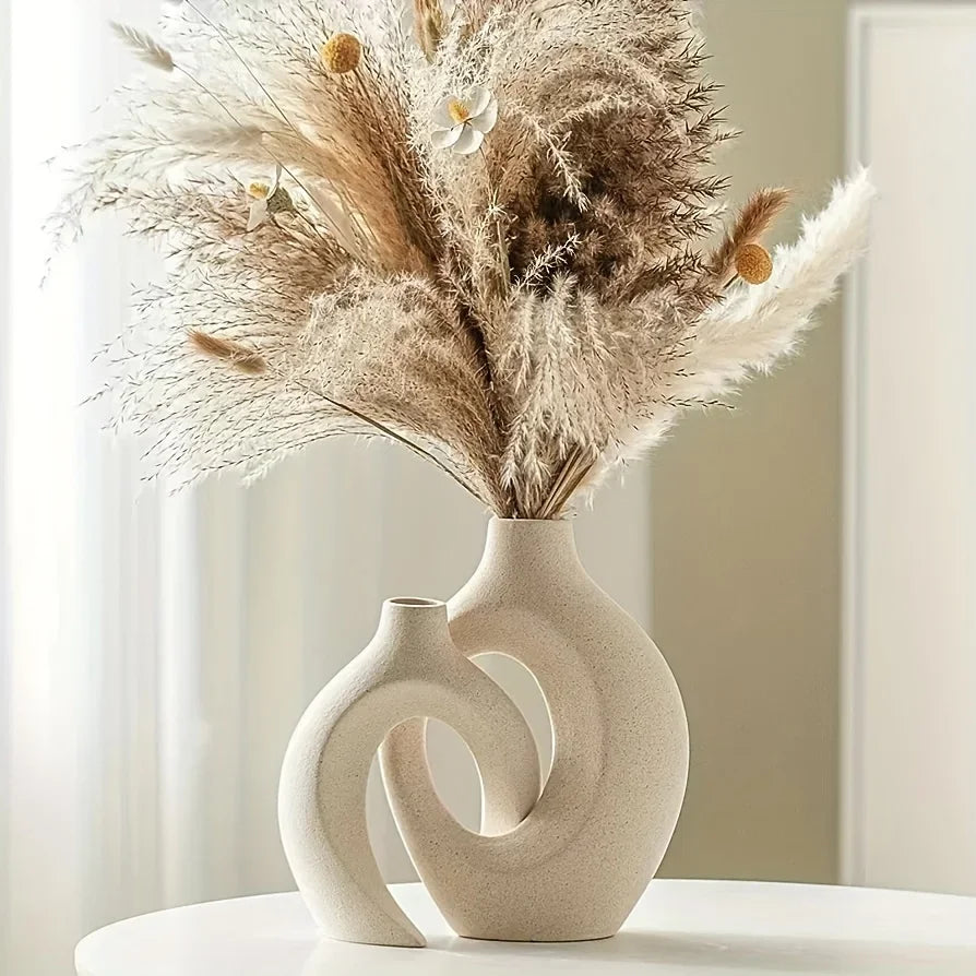 Sculptural Nordic ceramic vase with dried pampas grass on a light background, minimalist home decor