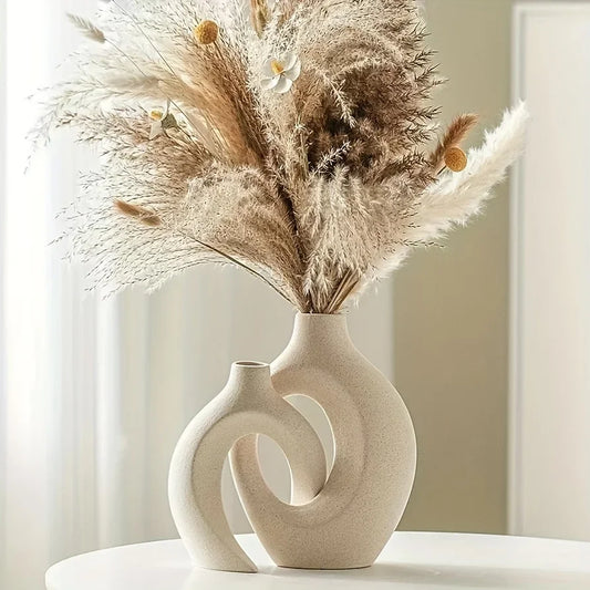 Sculptural Nordic ceramic vase with dried pampas grass on a light background, minimalist home decor