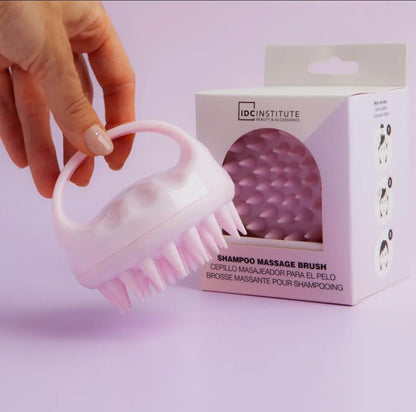 Scalp massage brush used during shampooing to improve circulation and hair care
