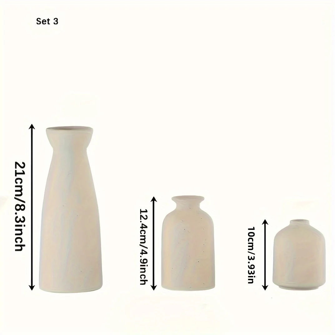 White ceramic vases lying on a neutral surface, minimalist decoration.